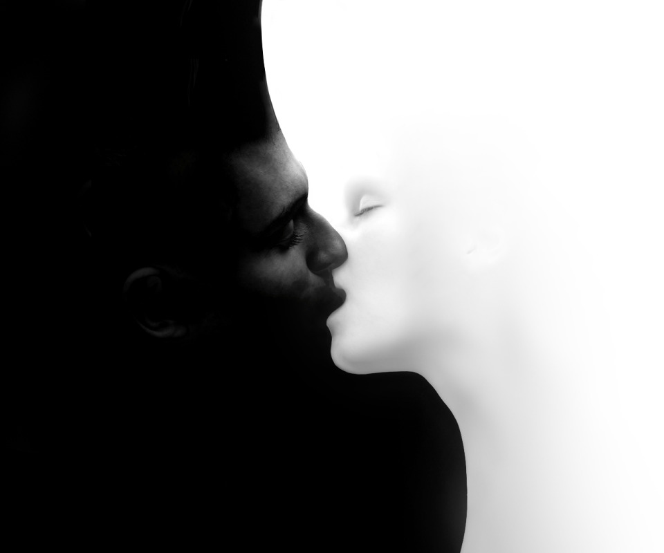 Black and white man kissing woman